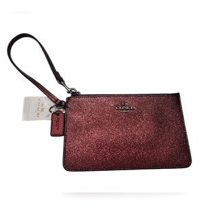 Coach wristlet. Color matallic cherry.